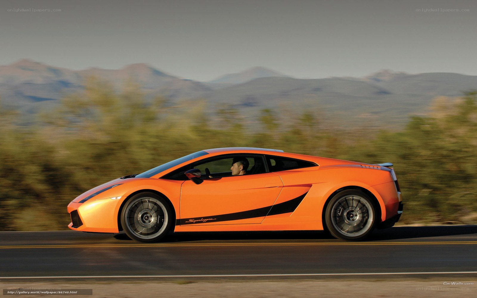 Orange Lamborghini driving on road