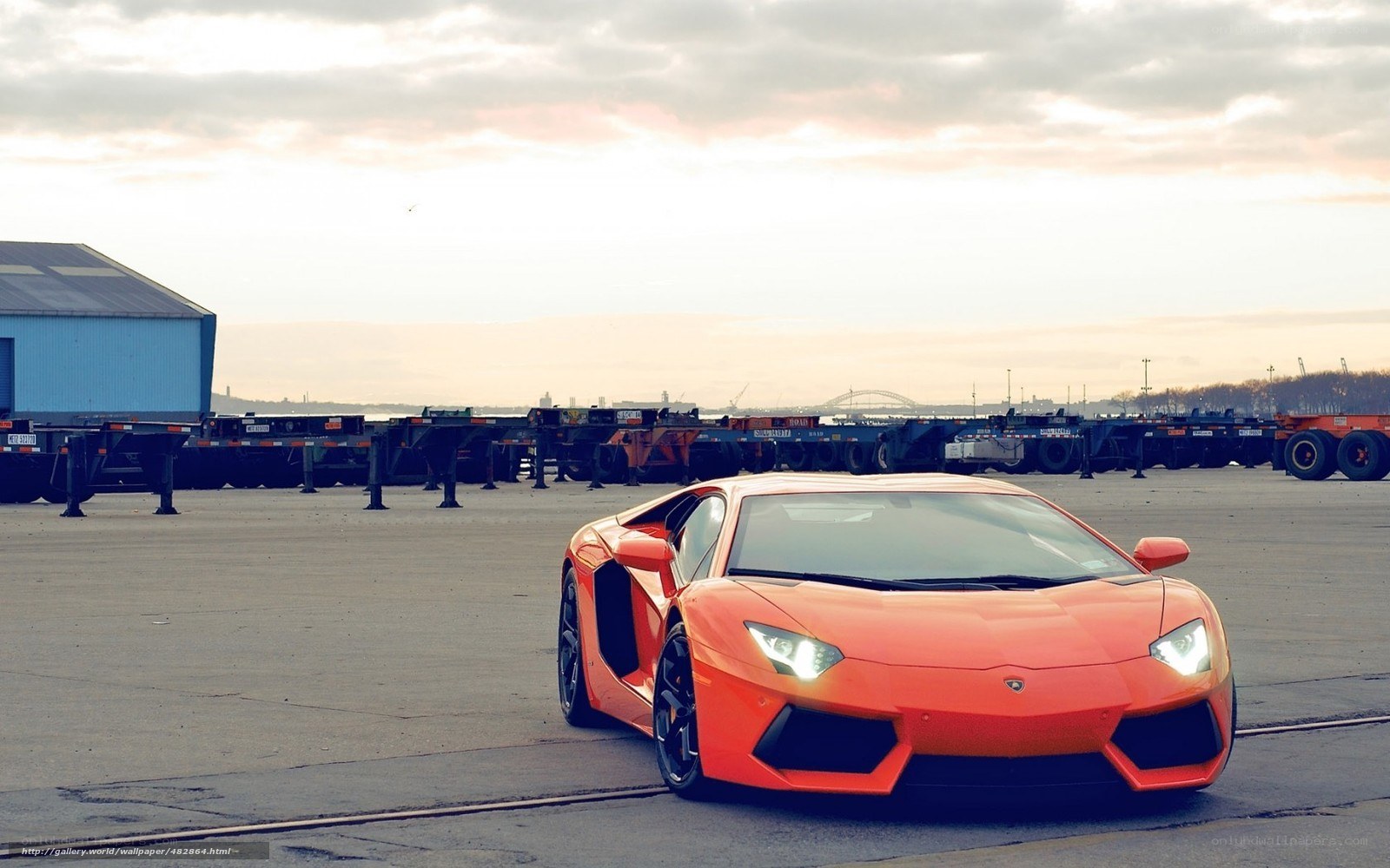 Orange Lamborghini in a shipping yard
