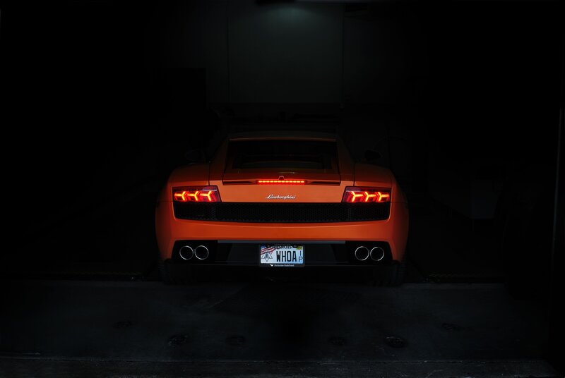 Orange Lamborghini in dark garage