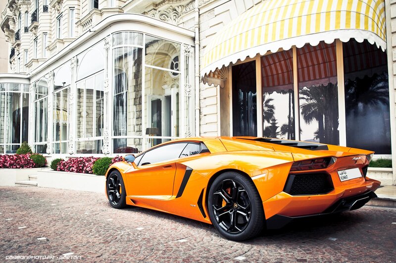 Orange Lamborghini in front of hotel
