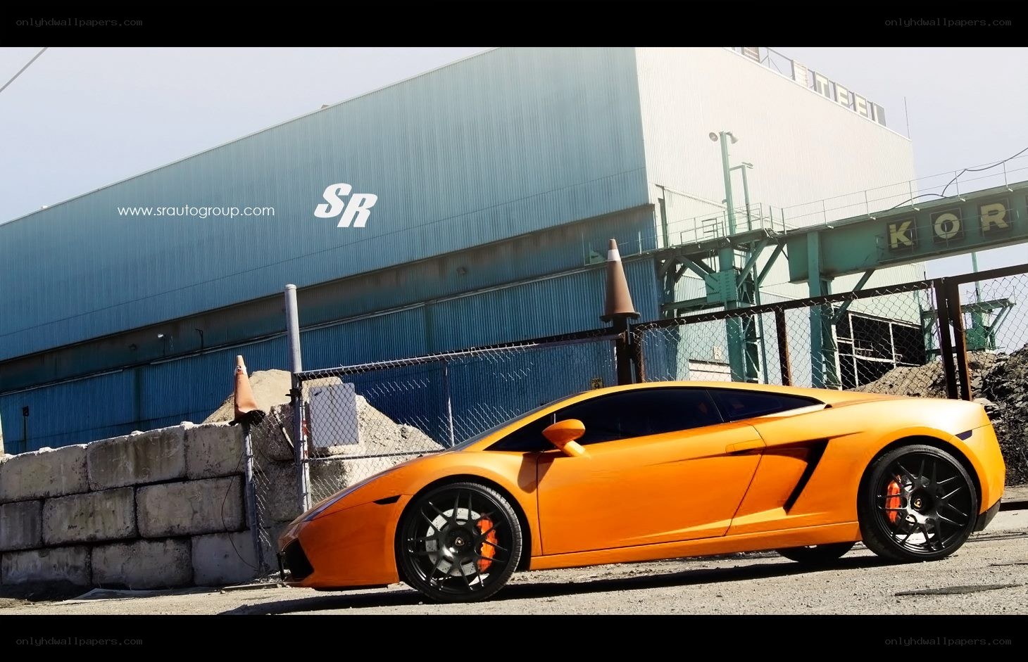 Orange Lamborghini in industrial setting