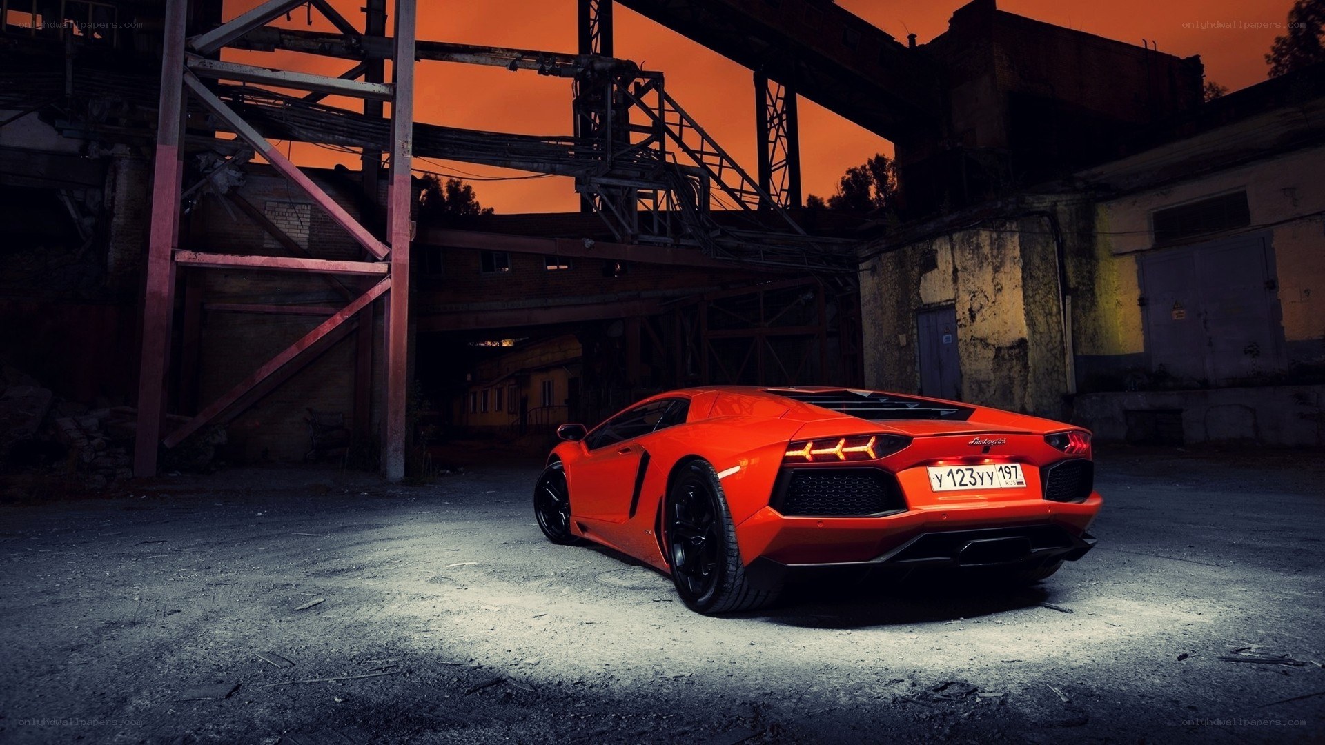 Orange Lamborghini in industrial setting
