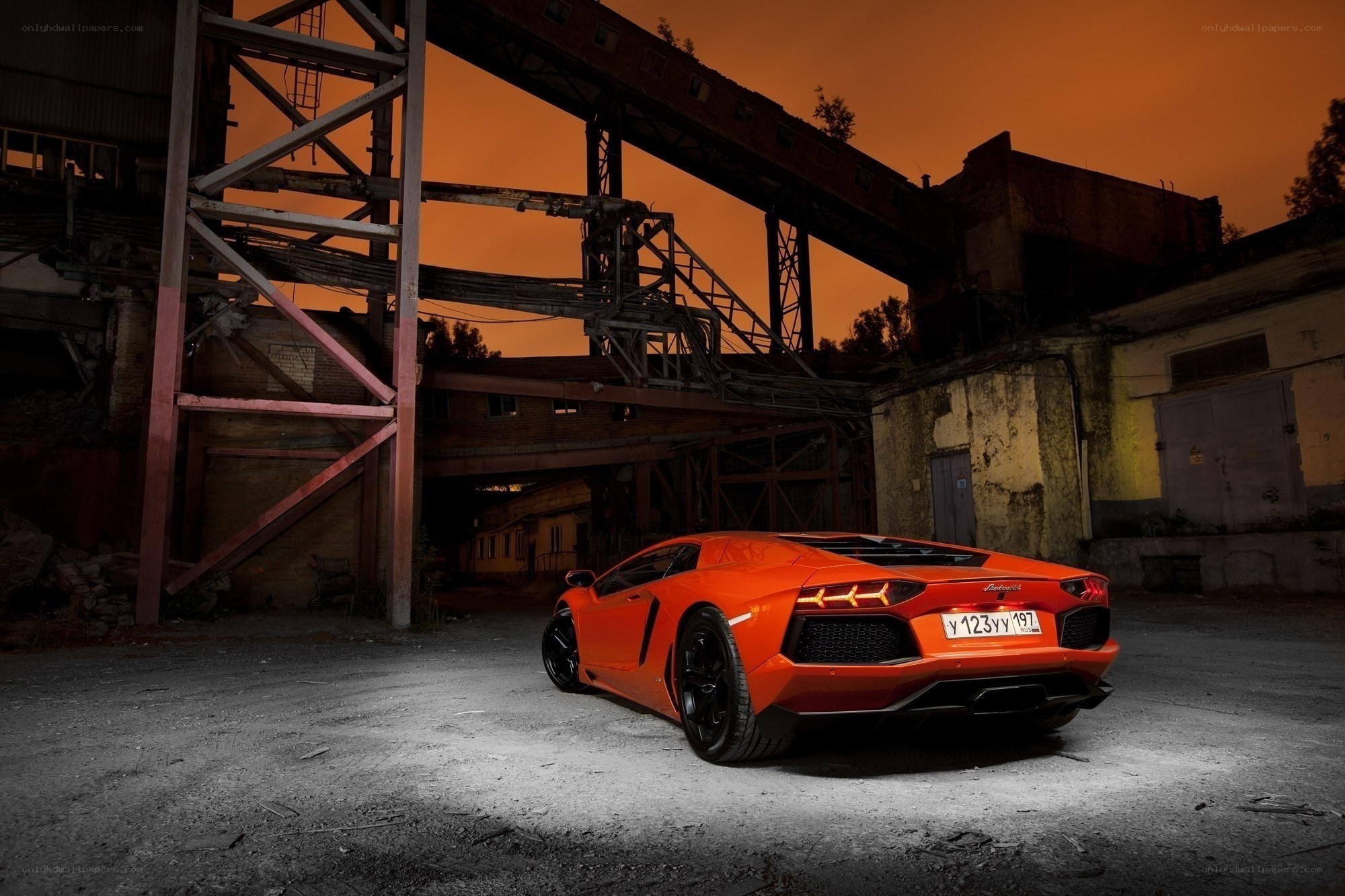 Orange Lamborghini in industrial setting