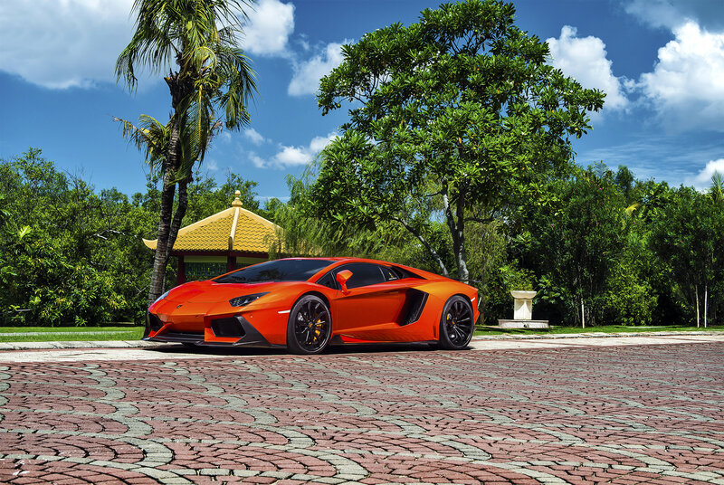 Orange Lamborghini in tropical garden