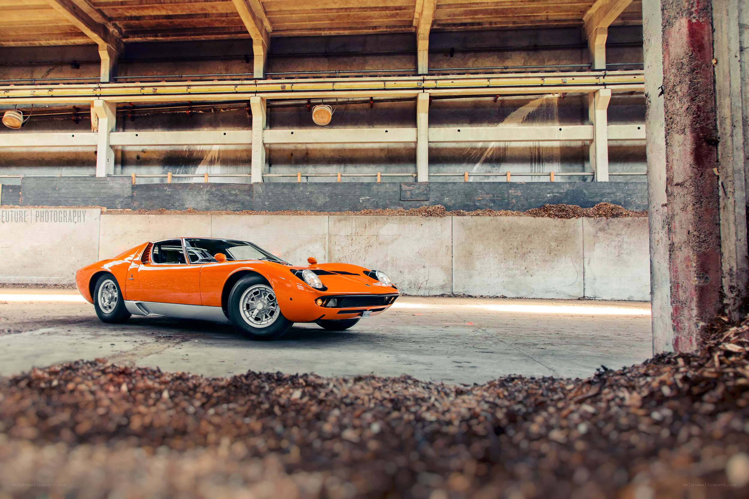 Orange Lamborghini Miura in warehouse