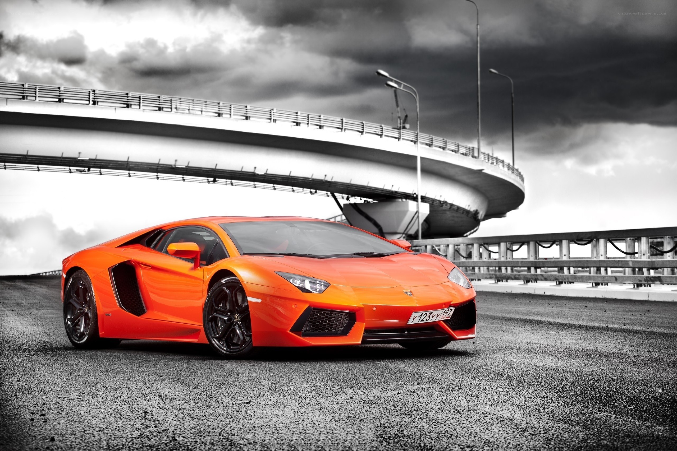 Orange Lamborghini on a bridge