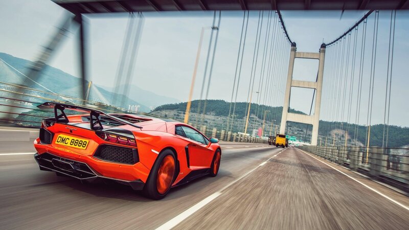 Orange Lamborghini on a bridge