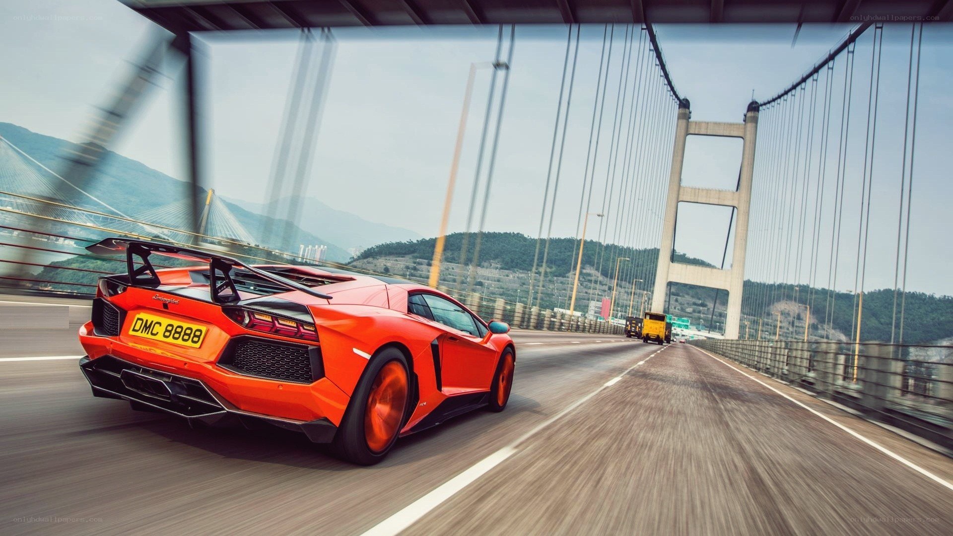 Orange Lamborghini on a bridge
