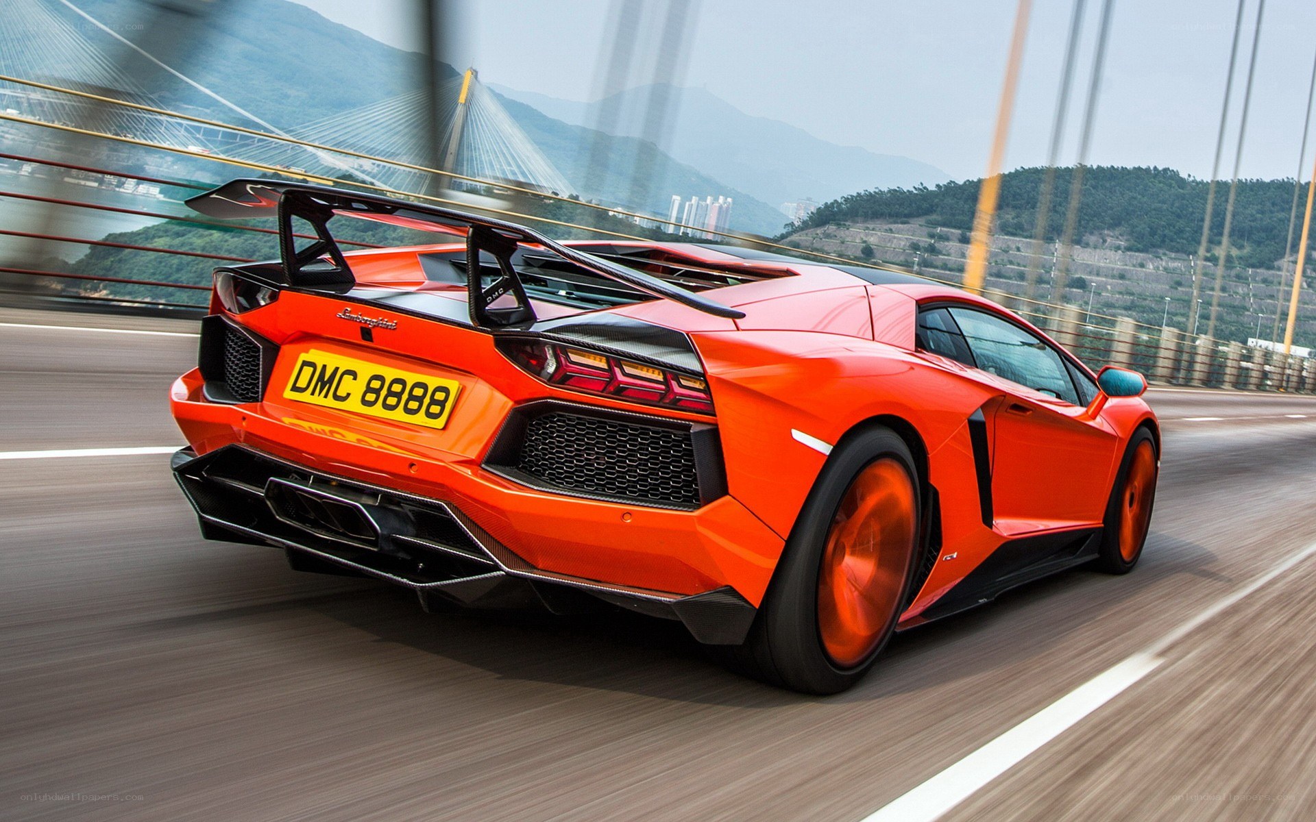 Orange Lamborghini on a bridge