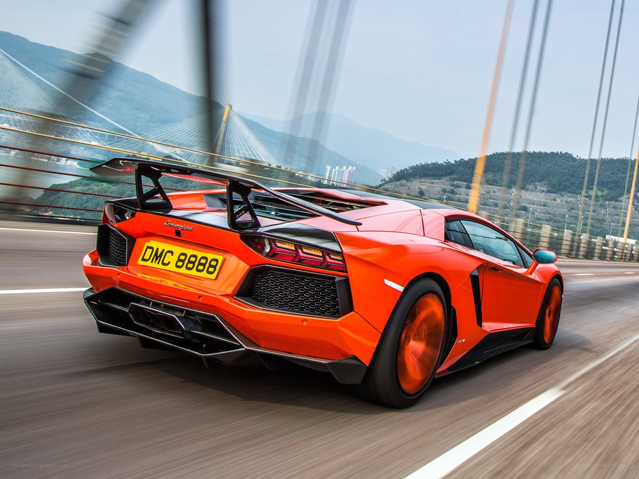 Orange Lamborghini on a bridge