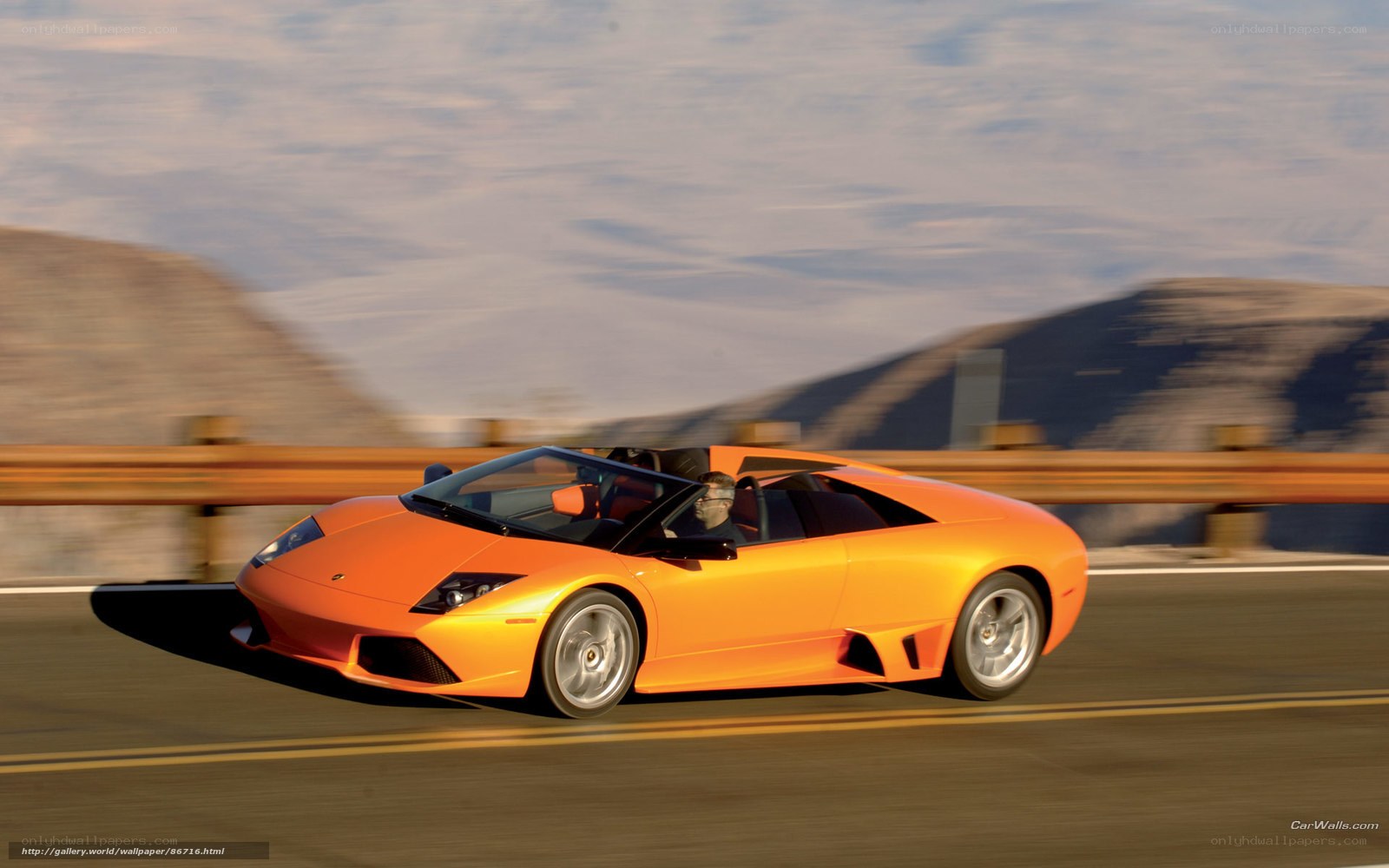 Orange Lamborghini on a mountain road