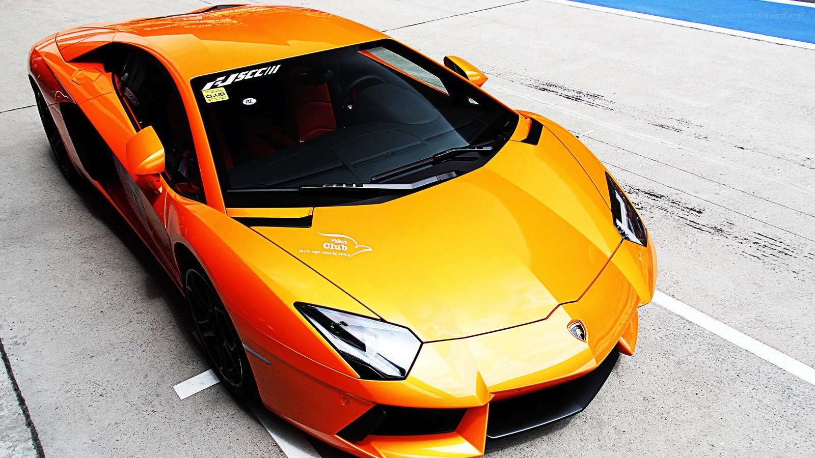 orange Lamborghini on a racetrack