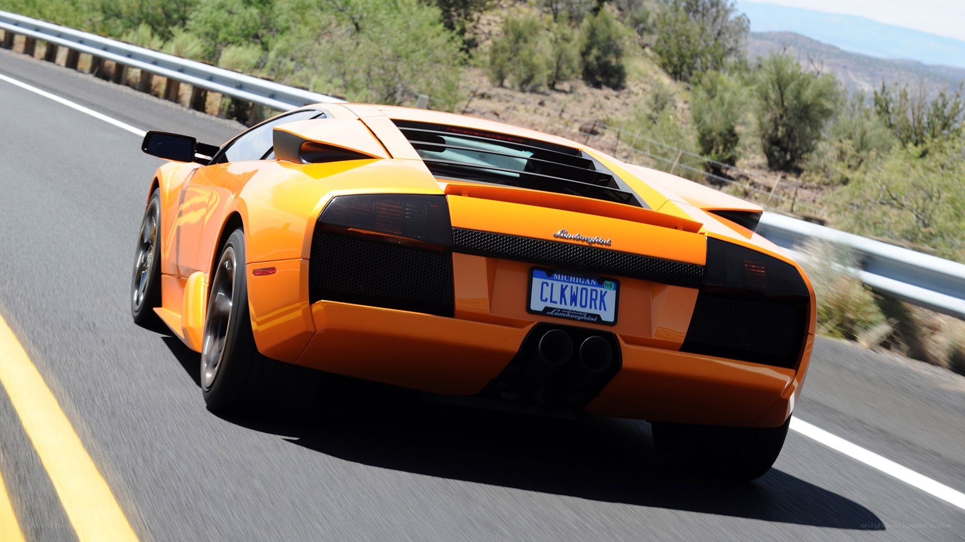 orange Lamborghini on a winding road