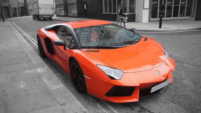 Orange Lamborghini on city street