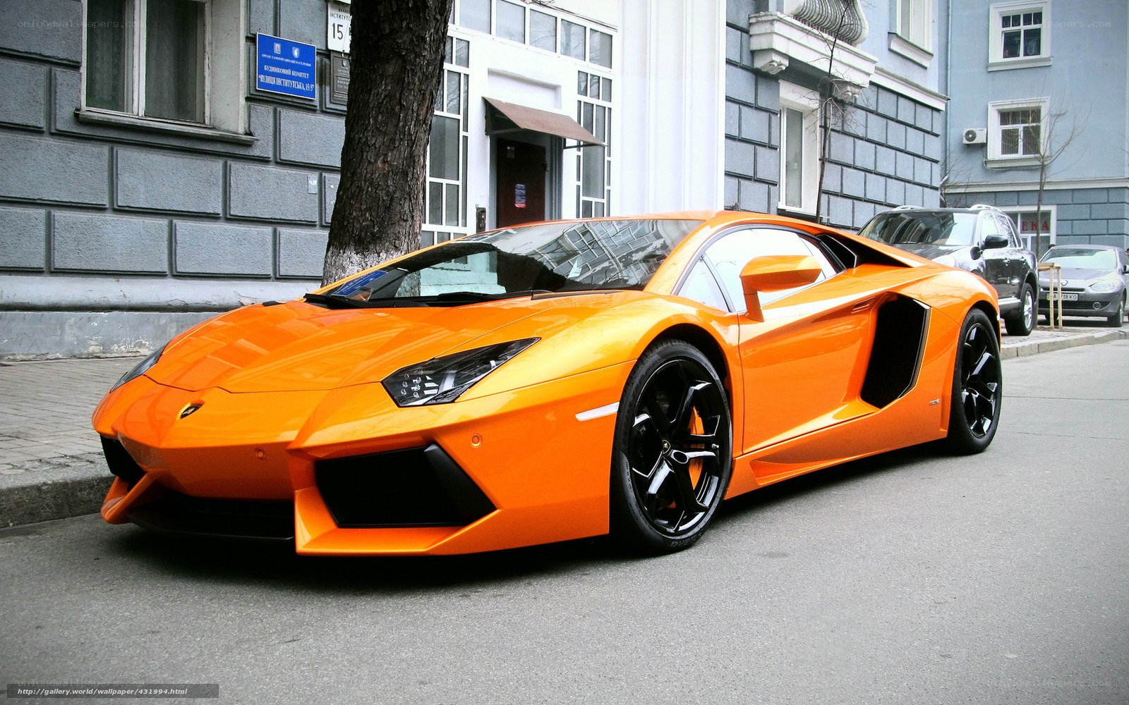 Orange Lamborghini on city street