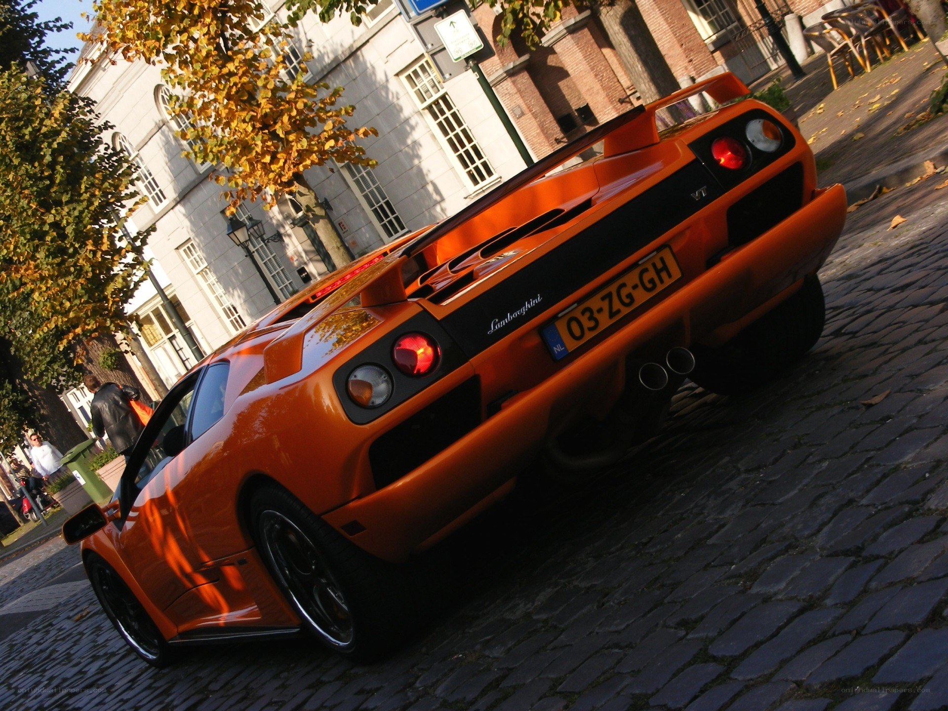 Orange Lamborghini on cobblestones