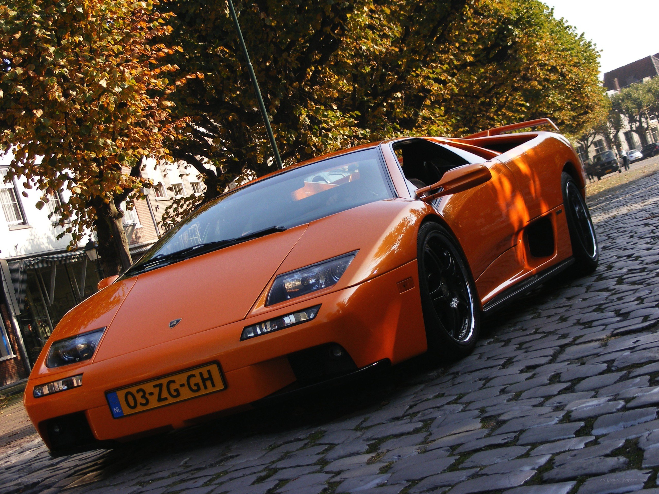 Orange Lamborghini on cobblestones