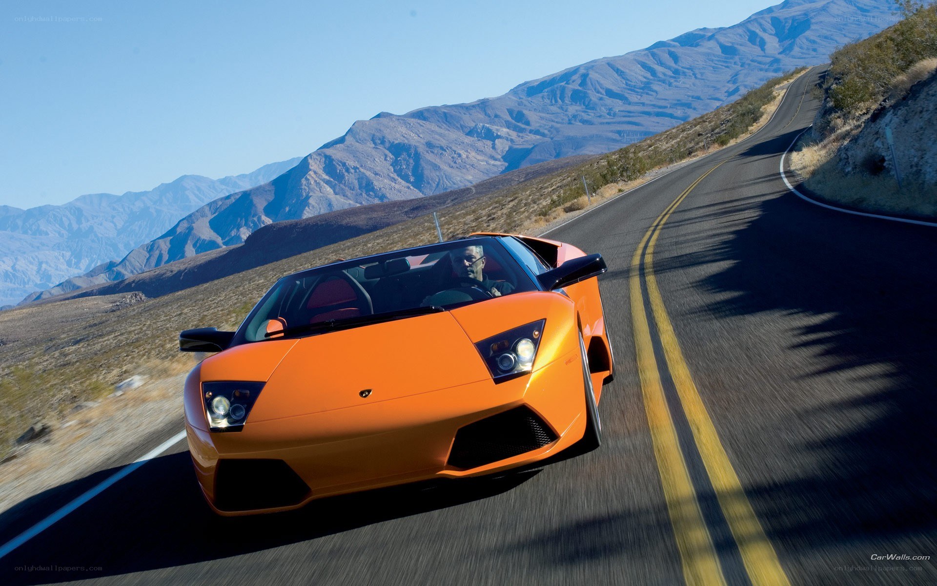 Orange Lamborghini on mountain road