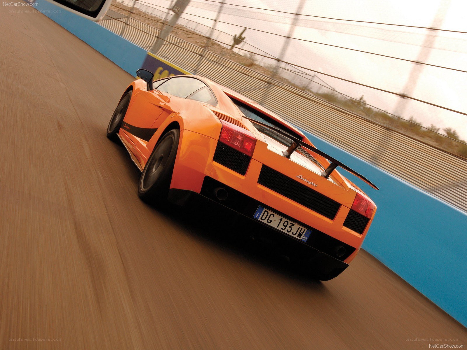 orange lamborghini on racetrack