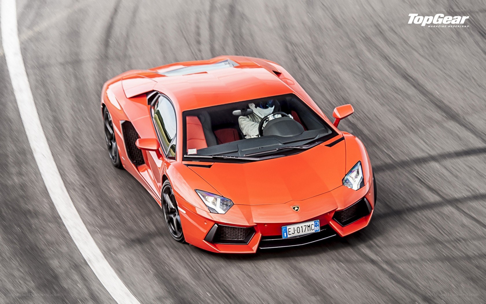 orange Lamborghini on racetrack