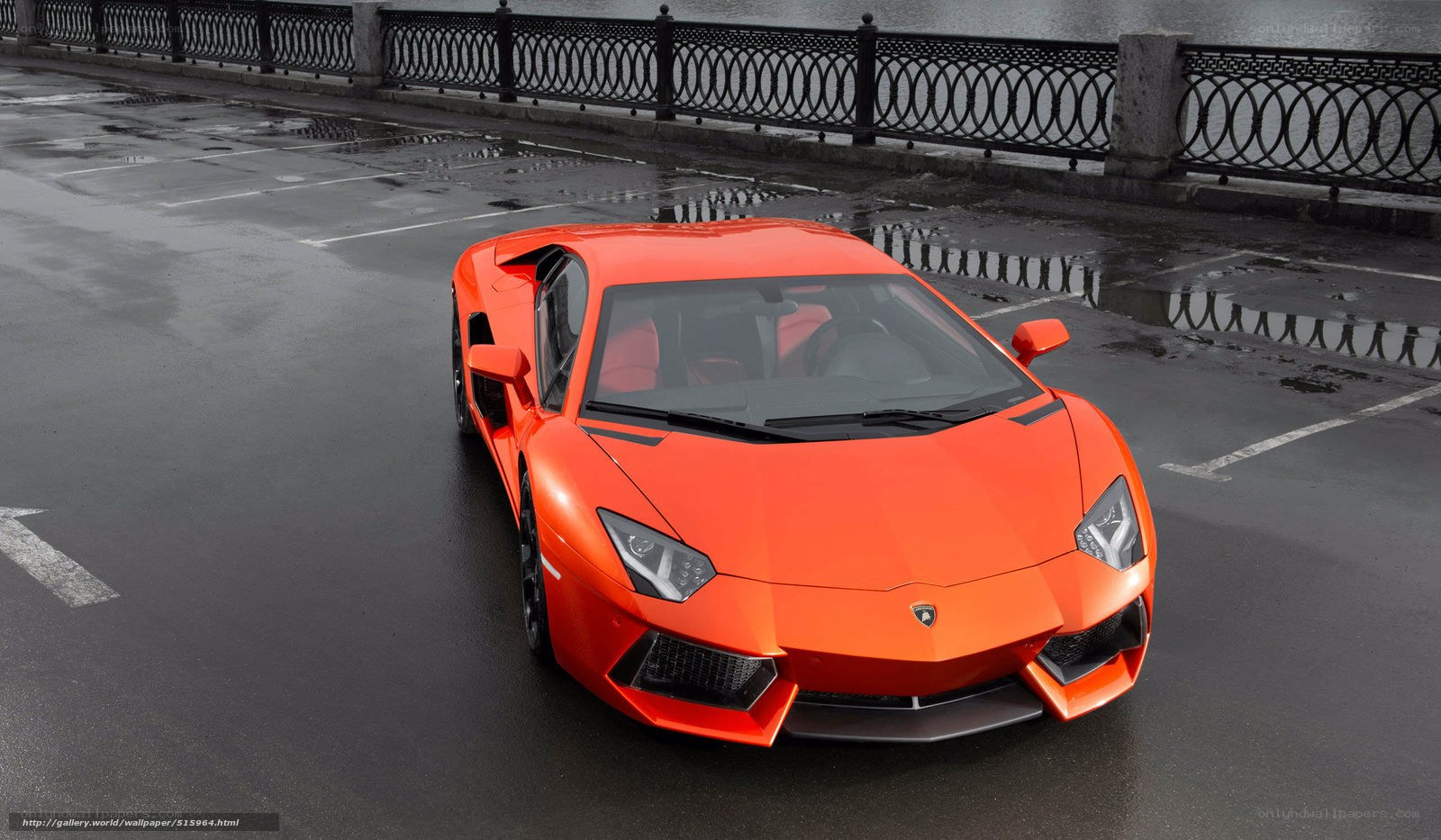 Orange Lamborghini on wet pavement