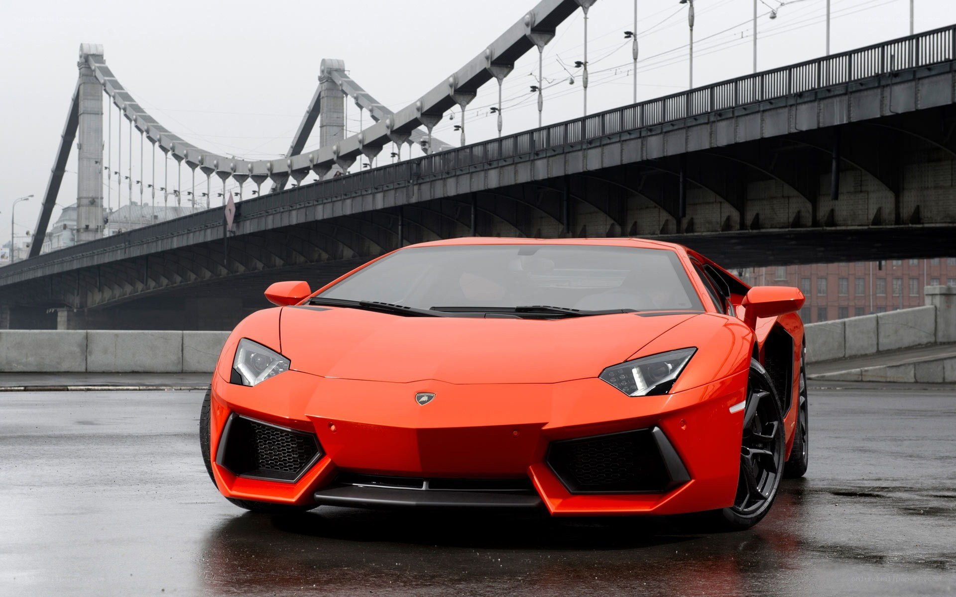 Orange Lamborghini on wet road