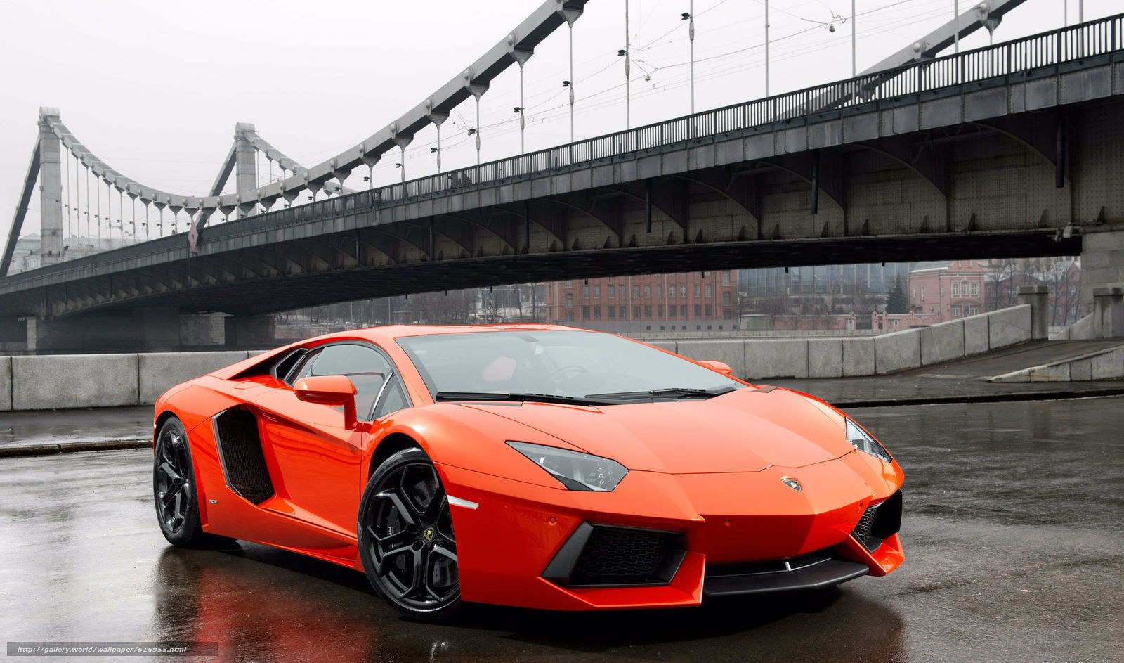 Orange Lamborghini on wet road