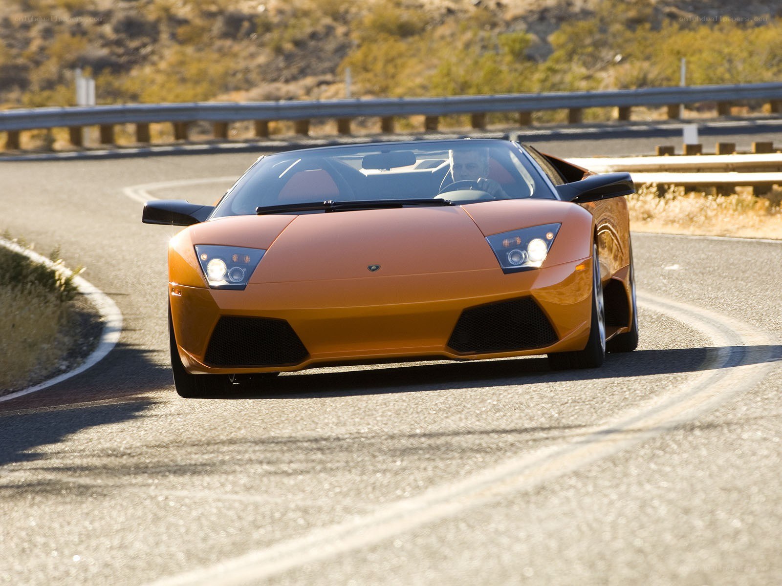 Orange Lamborghini on winding road