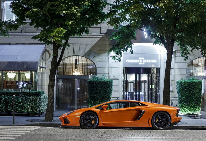 Orange Lamborghini outside hotel