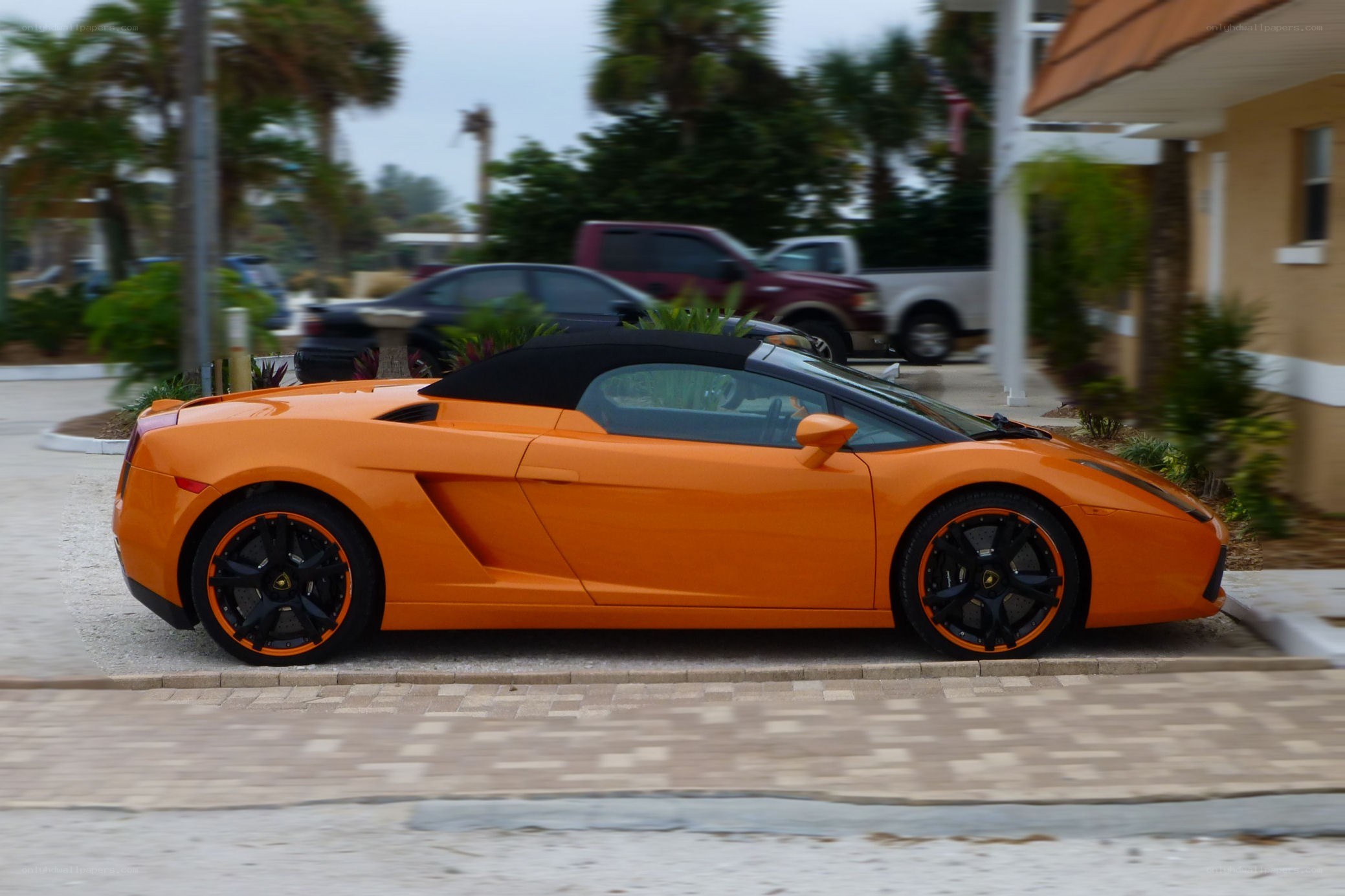 orange Lamborghini parked on street