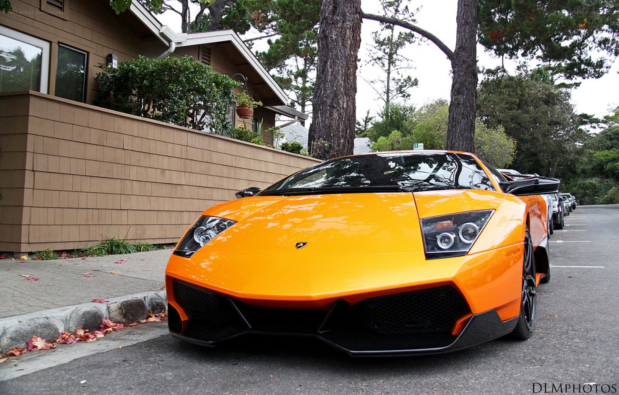 orange lamborghini parked on street