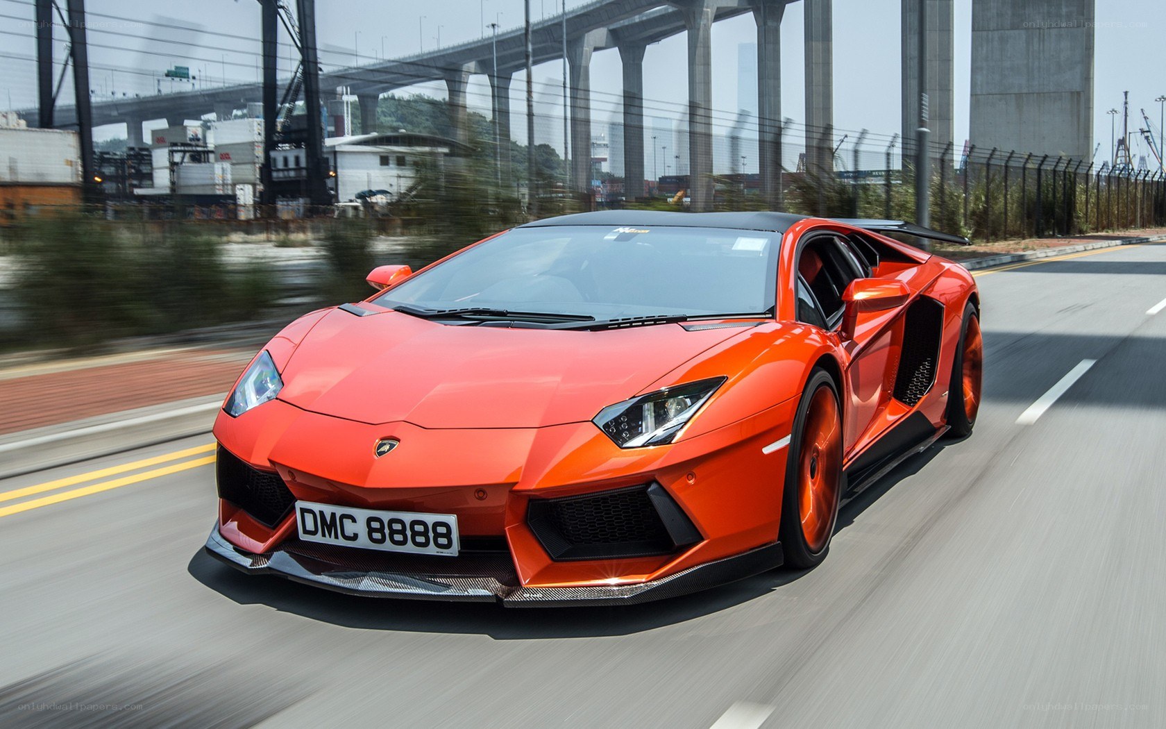 orange Lamborghini speeding on road