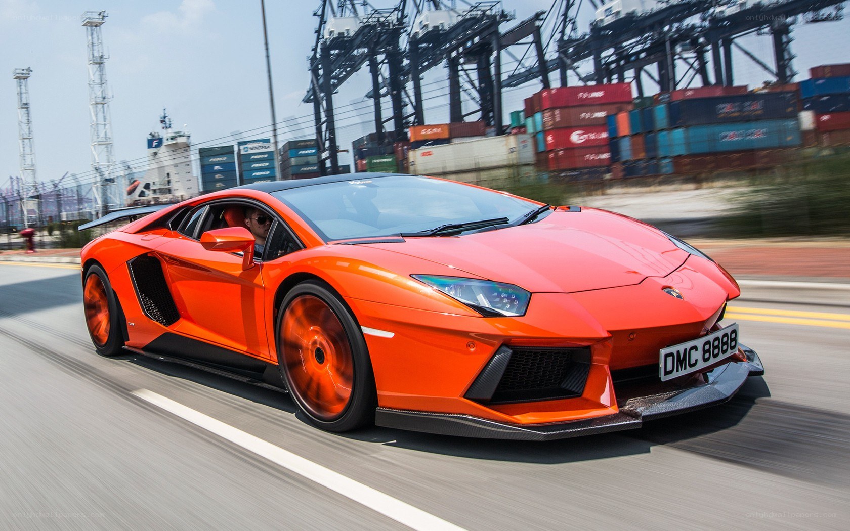 Orange Lamborghini speeding on road