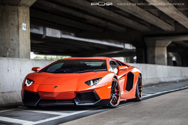 Orange Lamborghini under bridge