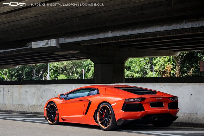 Orange Lamborghini under overpass