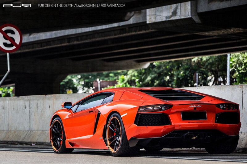 Orange Lamborghini under overpass