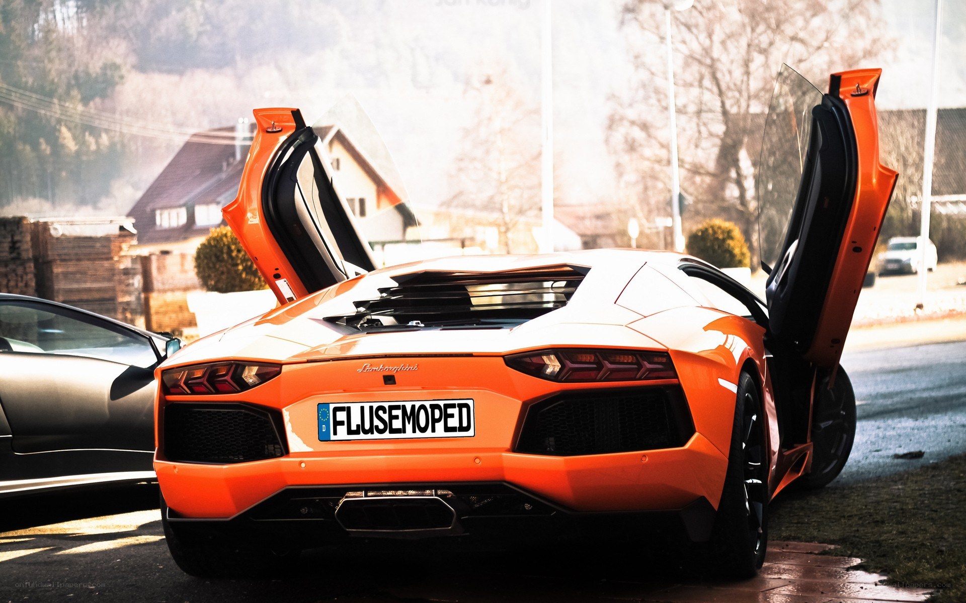 Orange Lamborghini with doors open