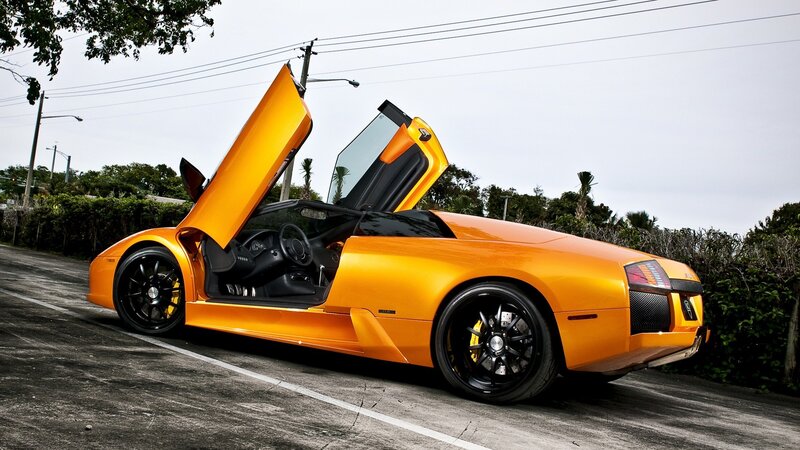 orange Lamborghini with doors open