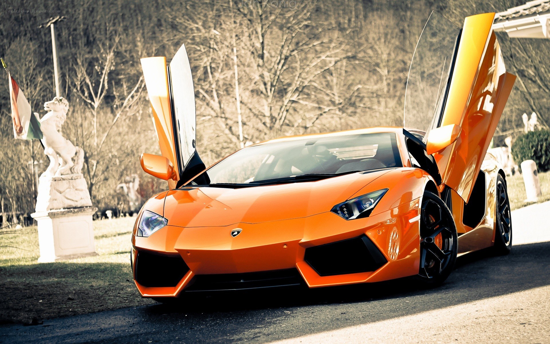 orange Lamborghini with doors open