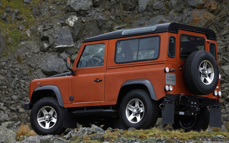 Orange Land Rover Defender — Outdoor, Photograph, Rocky Terrain, Spare Tire