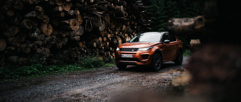 Orange Land Rover Discovery — Dramatic