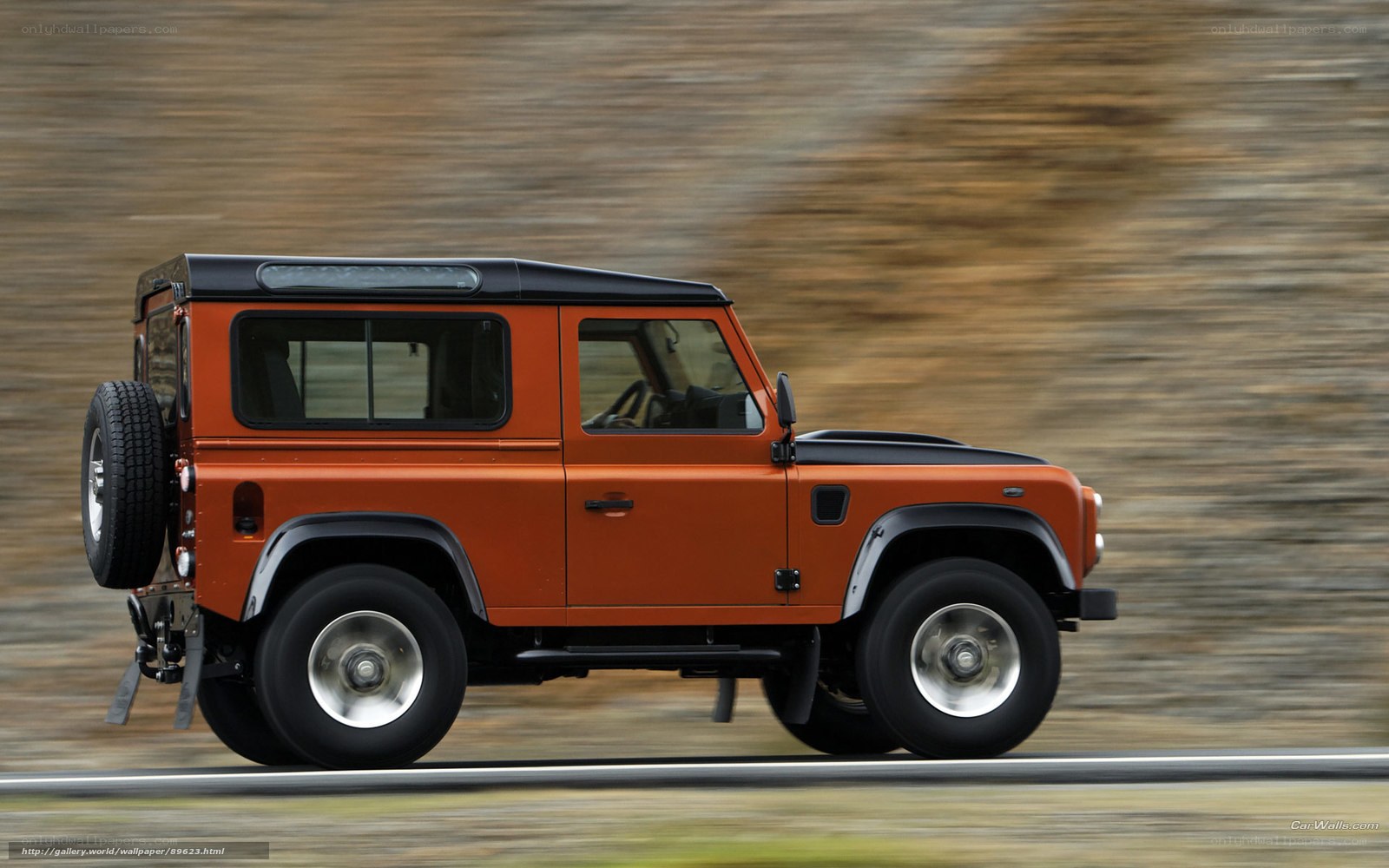 orange land rover driving