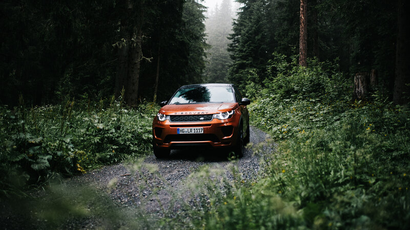 Orange Land Rover in Forest