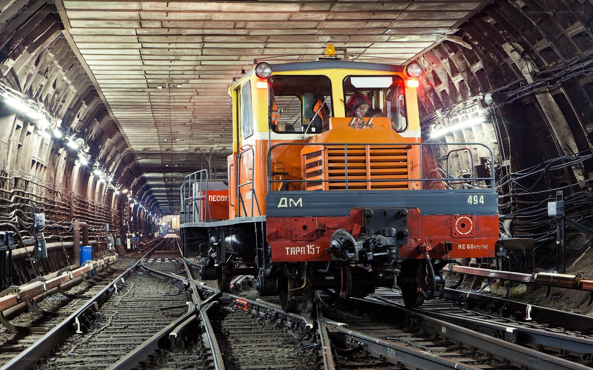Orange locomotive in tunnel