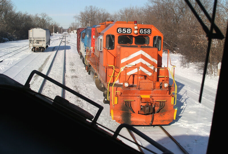 Orange locomotive on snowy tracks