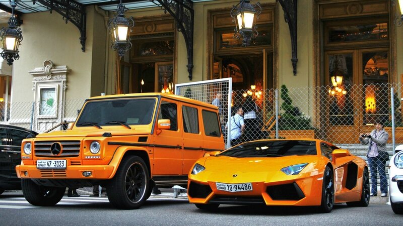 Orange luxury cars parked outside hotel