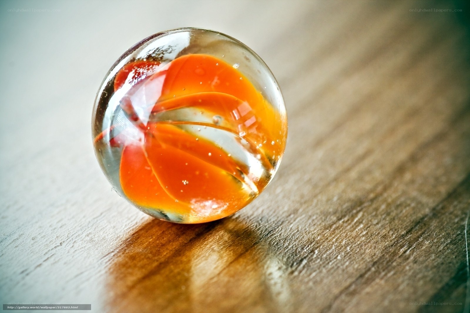 Orange marble on wooden surface