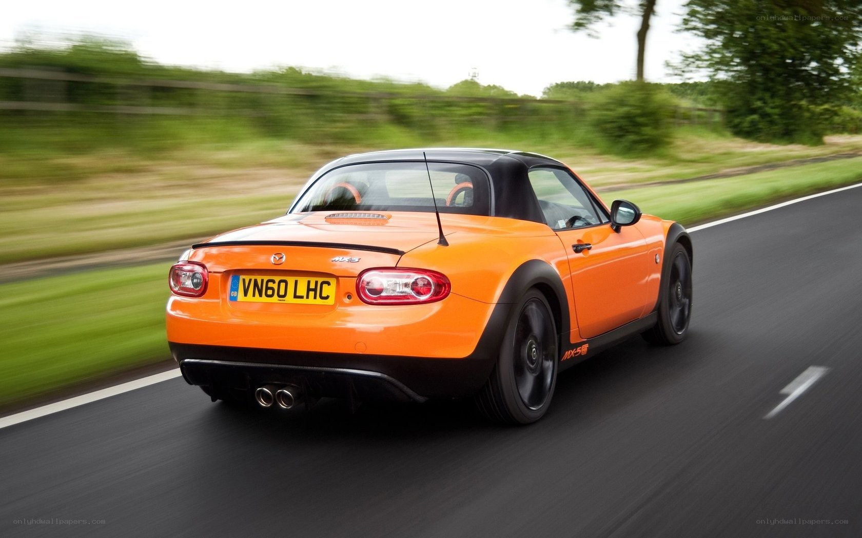 orange mazda mx-5 driving