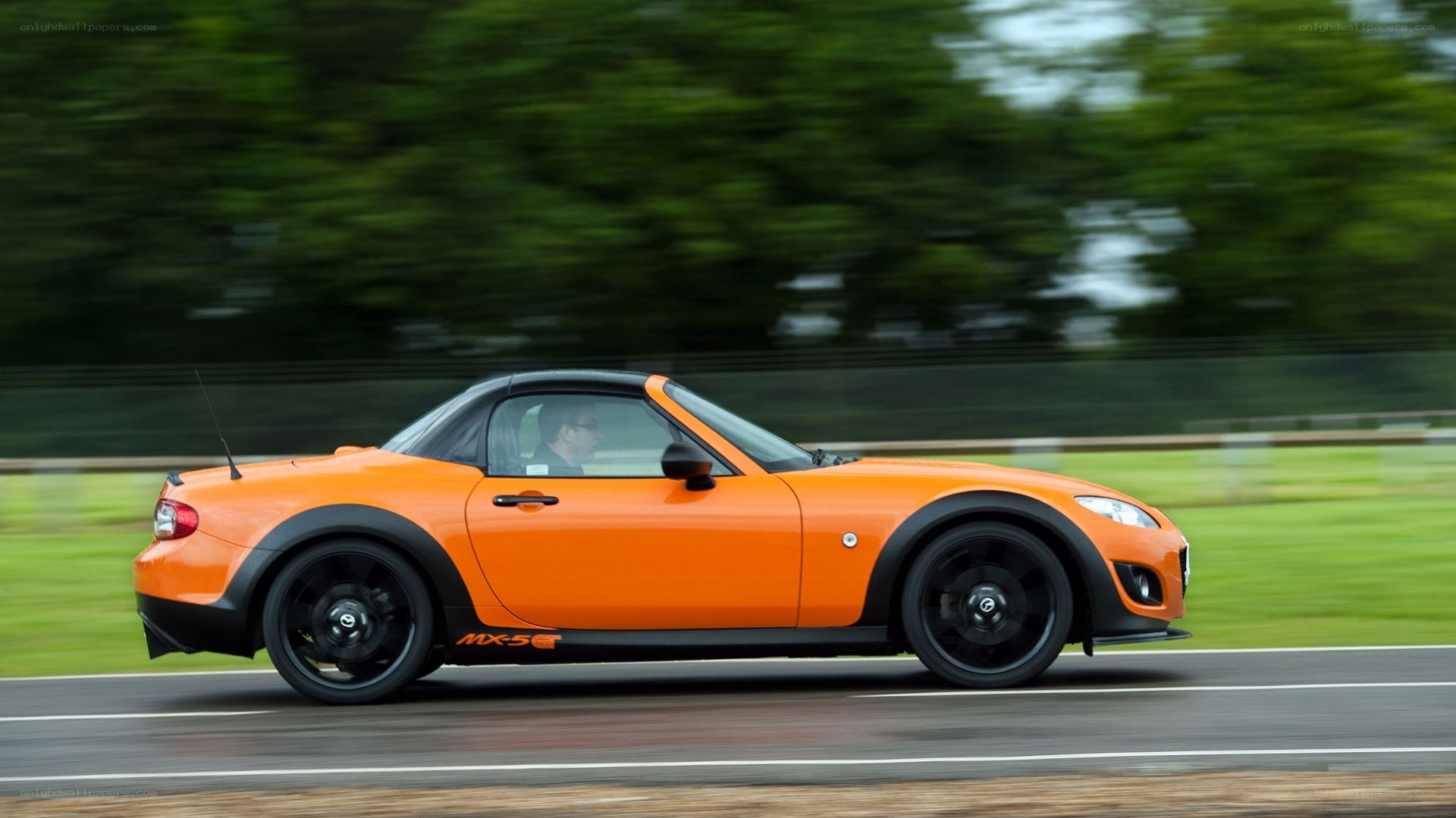 Orange Mazda MX-5 driving on track