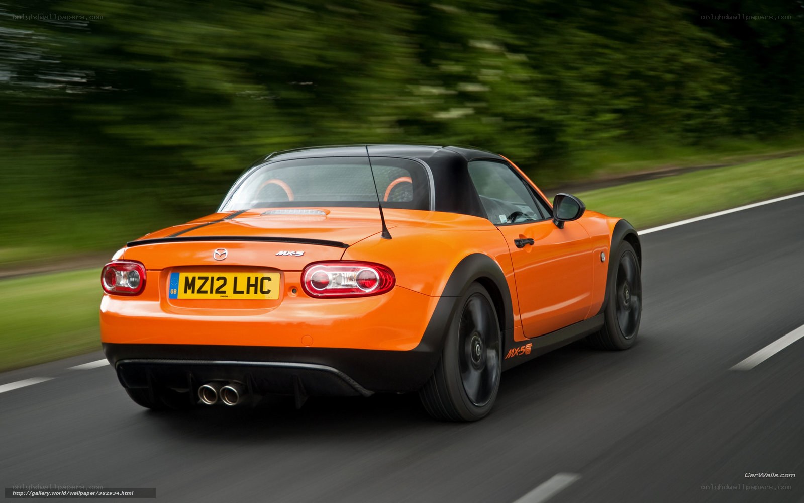 orange mazda mx-5 driving